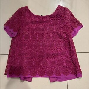 Hot pink lace/ embroidered top with black ties in the black.